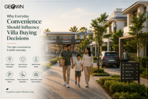 Premium villa community with Indian family walking along landscaped pathways near everyday conveniences including a supermarket, pharmacy, café, ample parking, and green open spaces, highlighting how easy access to essential amenities, secure surroundings, and thoughtful planning influence smarter villa buying decisions and enhance everyday living.