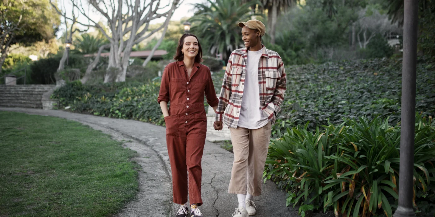 trans-couple-taking-walk-park-scaled