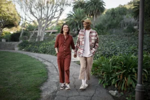 trans-couple-taking-walk-park-scaled