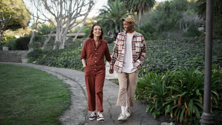trans-couple-taking-walk-park-scaled